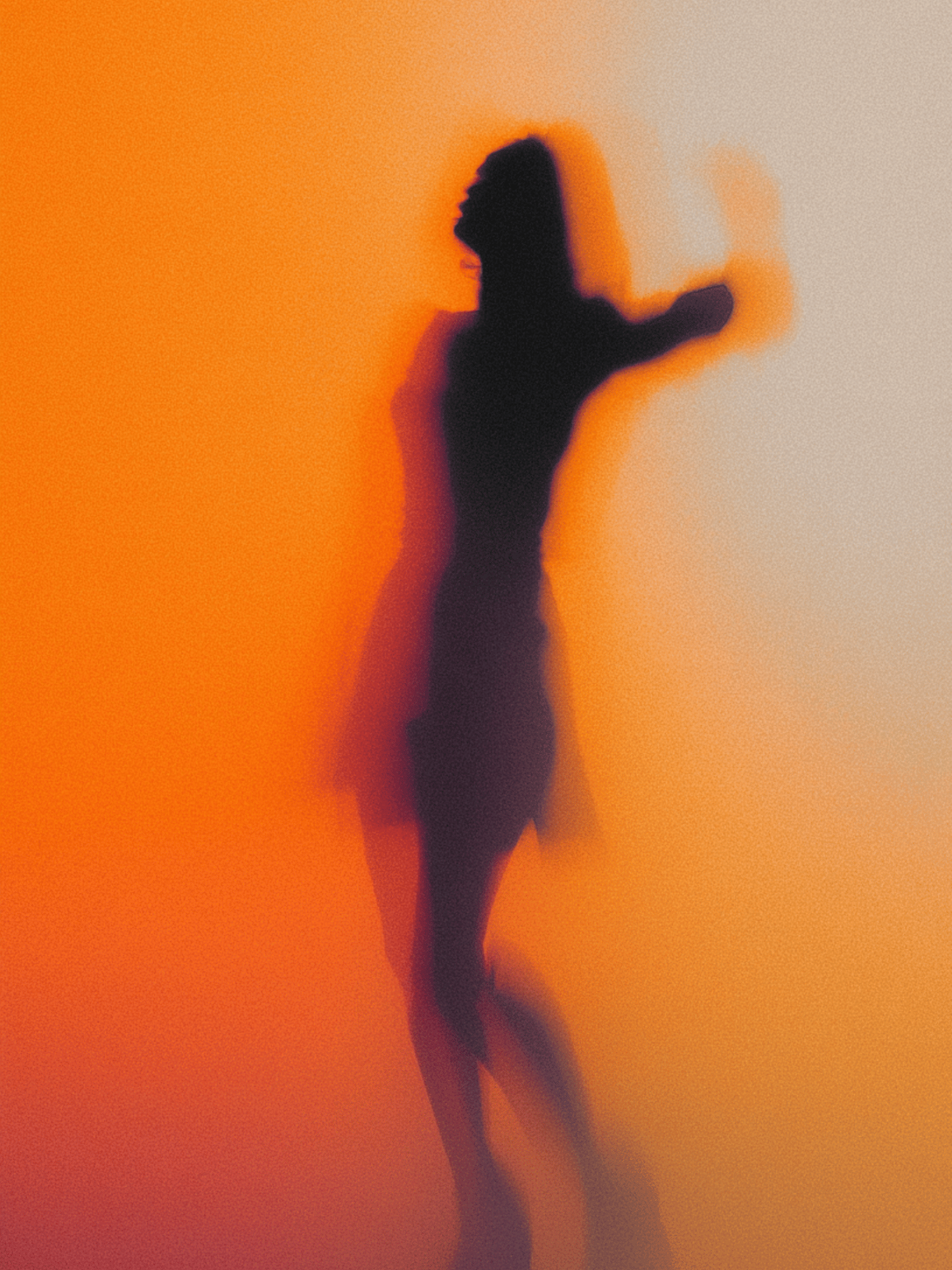 Dancing silhouette in orange haze